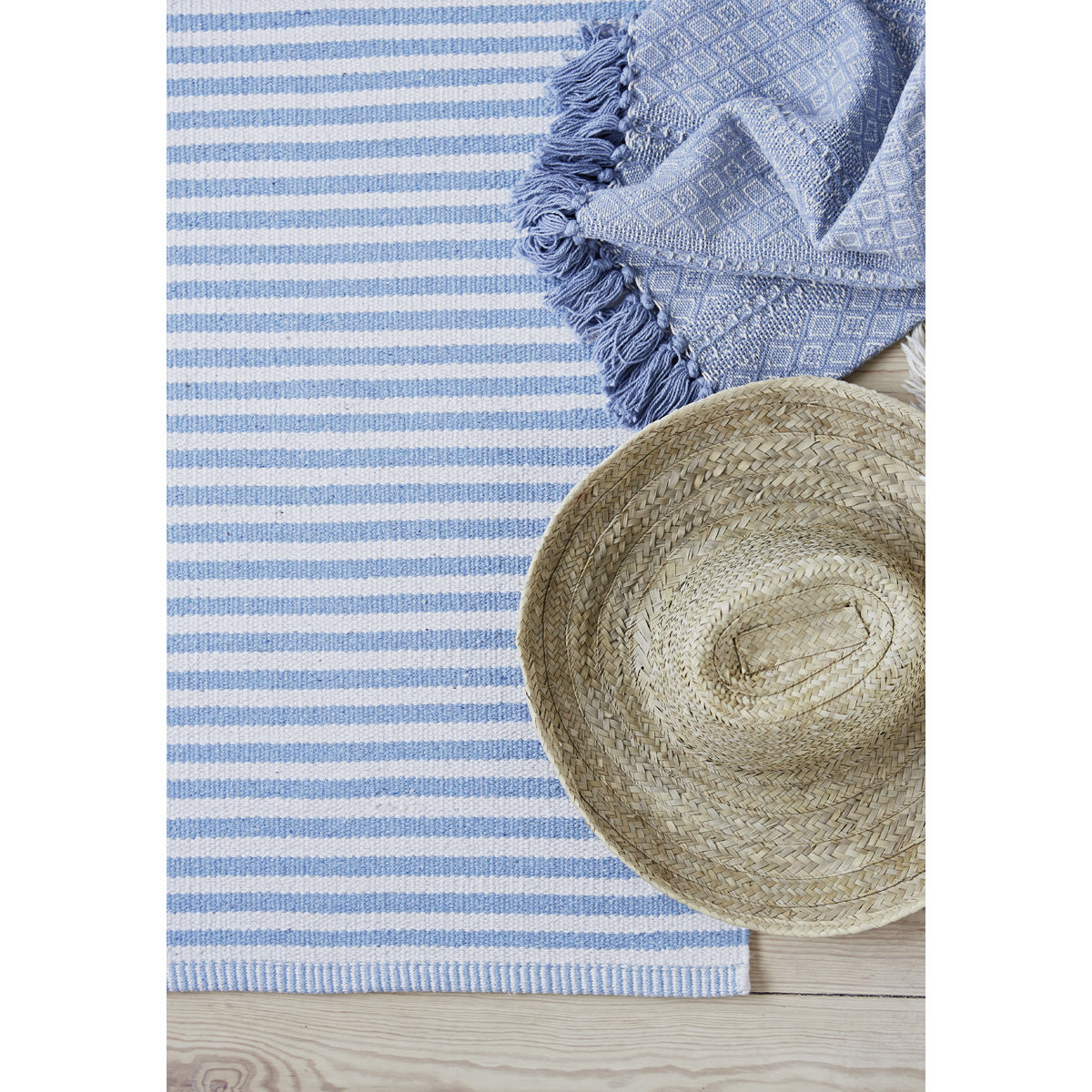 Paris Pale Blue and White Striped Recycled Cotton Rug styled with hat
