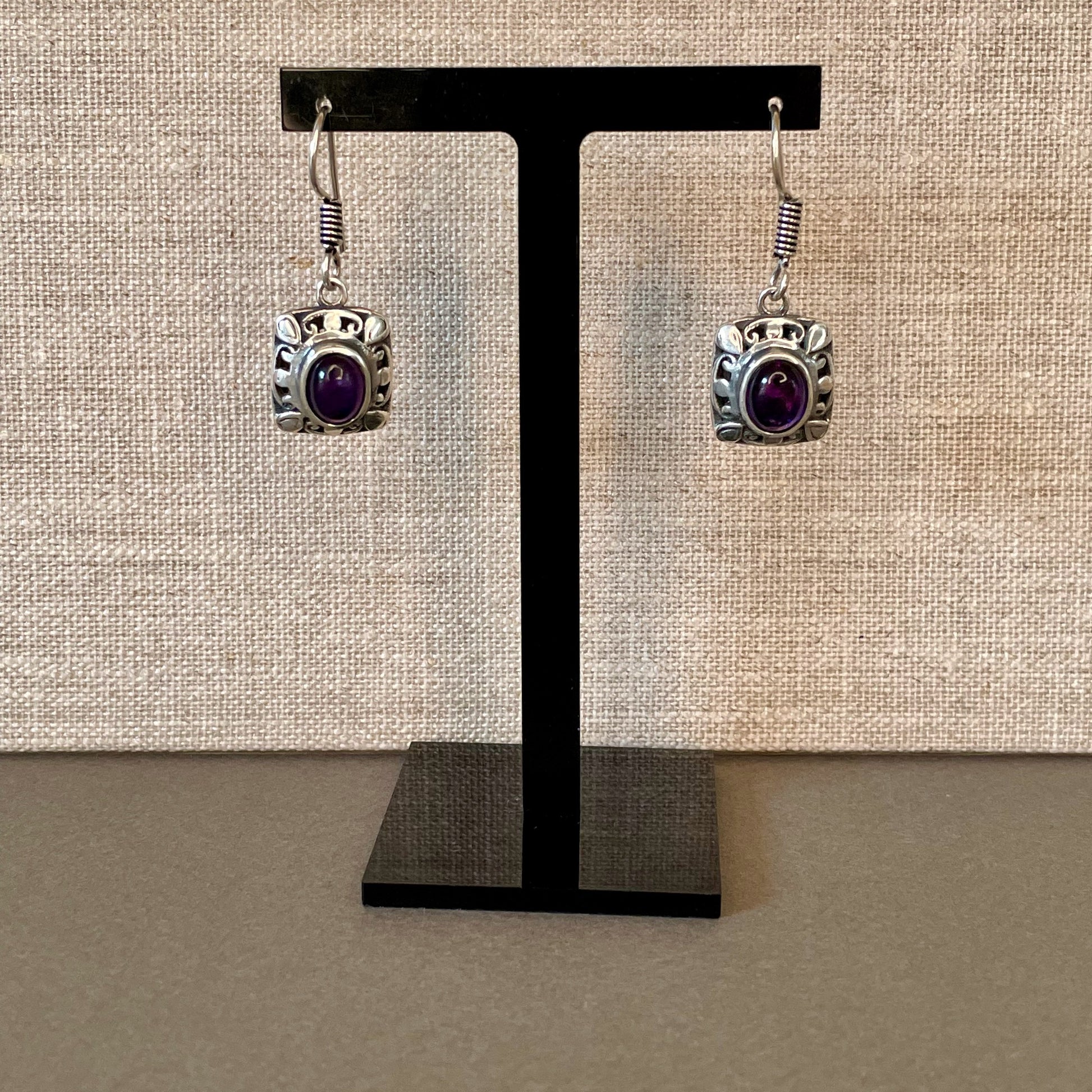 Fretwork Berber Silver Earrings with Oval purple Stones on stand